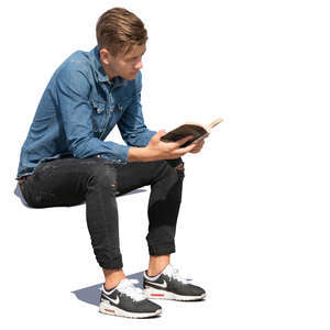 young man sitting and reading a book