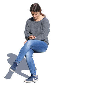 woman sitting and looking at her phone