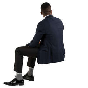 black man in a suit sitting