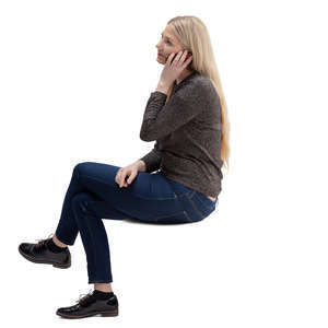 woman sitting and talking on a phone