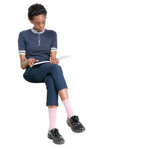 black woman sitting and reading a magazine