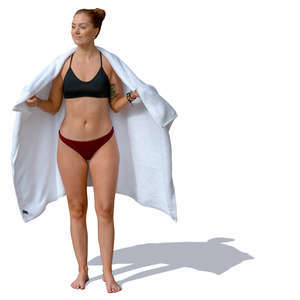 woman in a bathing suit standing and holding a towel