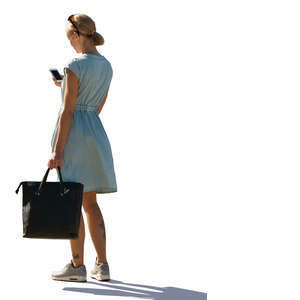 woman in a light blue summer dress standing