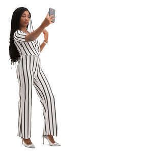 black woman in a striped jumpsuit taking a selfie