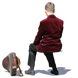 boy with a french horn case sitting