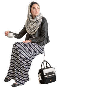 muslim woman sitting in a cafe