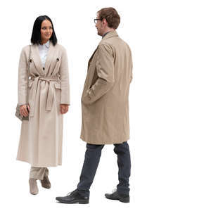 man and woman in overcoats standing and talking