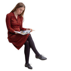 young woman sitting and reading a magazine