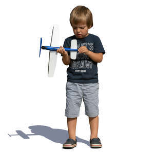 little boy playing with a toy plane