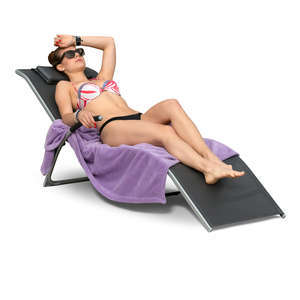 woman sunbathing on a beach chair