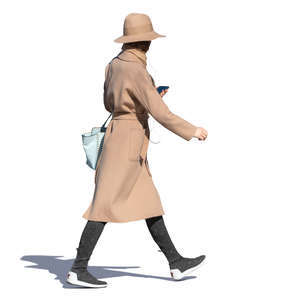 woman in a brown overcoat and hat walking