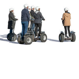 group of adults riding segways