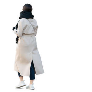 woman in a white overcoat walking