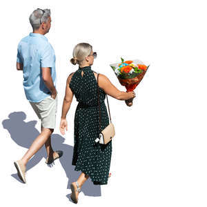 man and woman walking and carrying flowers seen from above
