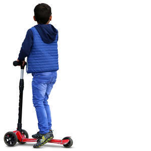 boy in a blue jacket riding a scooter