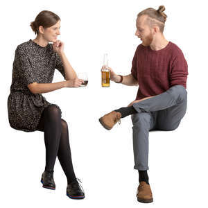 young man and woman sitting and talking in a cafe