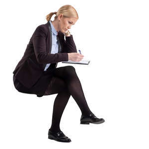 woman sitting and writing in an office