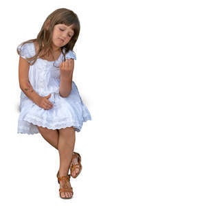 little girl in a white dress sitting