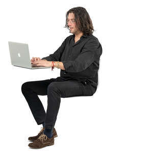 man sitting at a desk and working with laptop