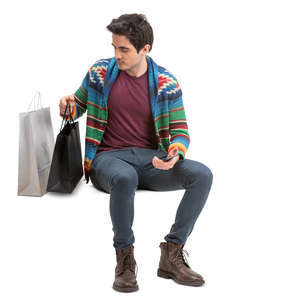 man with shopping bags sitting