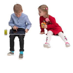 boy and girl sitting and looking at a tablet