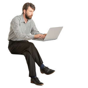 man sitting and working on a laptop