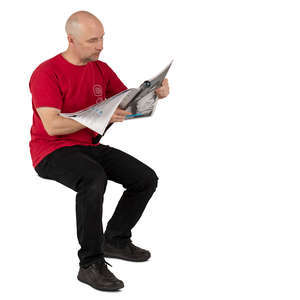 man in a red shirt sitting and reading a newspaper