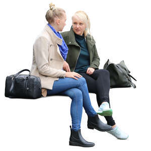 two women sitting on a bench and talking