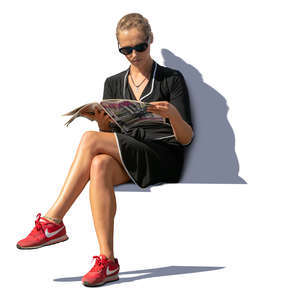 woman sitting on a bench and reading a magazine