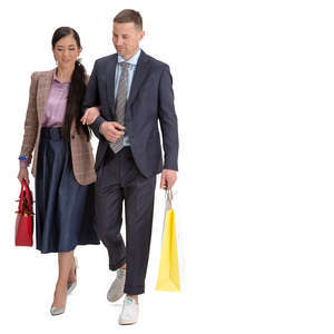 man and woman with shopping bags walking arm in arm