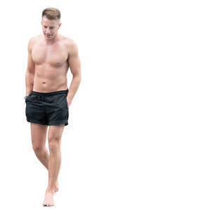 man in swimming shorts walking