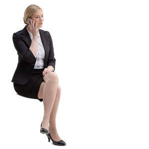 woman in an office sitting and talking on the phone