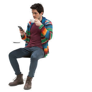 man sitting in a cafe and drinking coffee