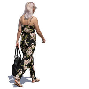 woman in a flower print jumpsuit walking