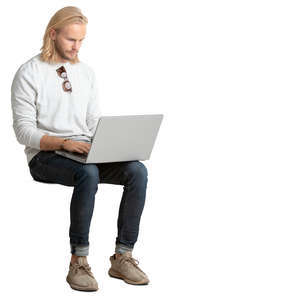 man sitting and working on his laptop