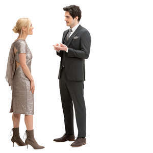 man and woman in party clothes standing and talking