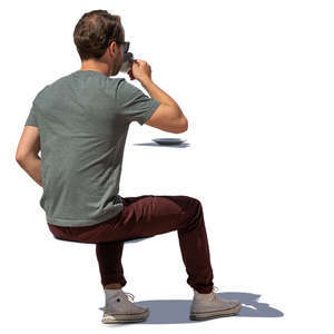 man sitting and drinking coffee on a sunny day