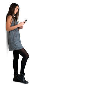 woman leaning against the wall and texting