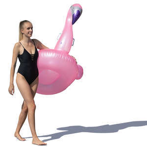 woman walking with a pink floatable flamingo