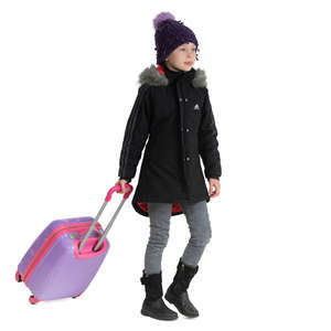 little girl in a winter coat pulling a suitcase