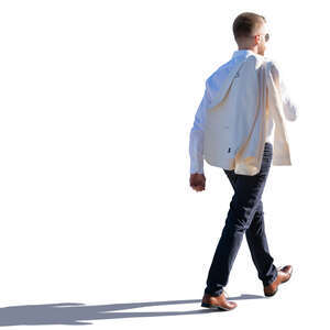 backlit man walking with a jacket over his shoulder