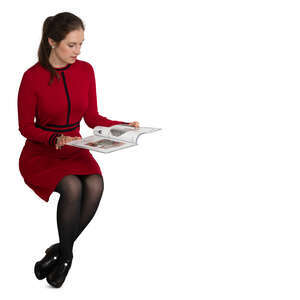 woman in a red dress reading a magazine