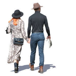 couple with hats walking hand in hand