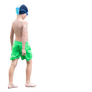 boy in swimming trunks walking