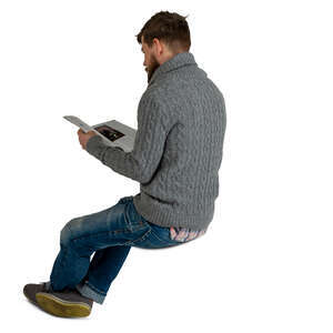 man sitting and reading a magazine