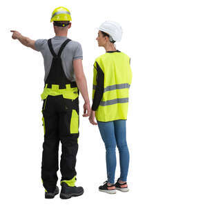 man and woman with helmets standing on construction site