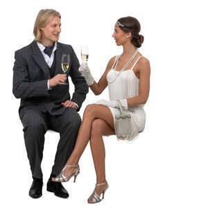 man and woman in fancy clothes sitting and drinking champagne