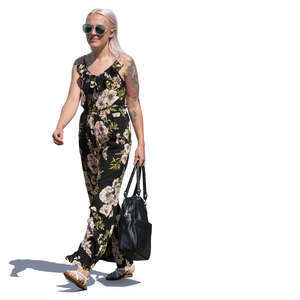 woman in a flower print jumpsuit walking