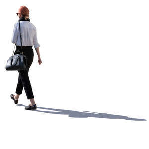 backlit woman walking on a street