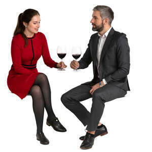 man and woman sitting in a restaurant and drinking wine